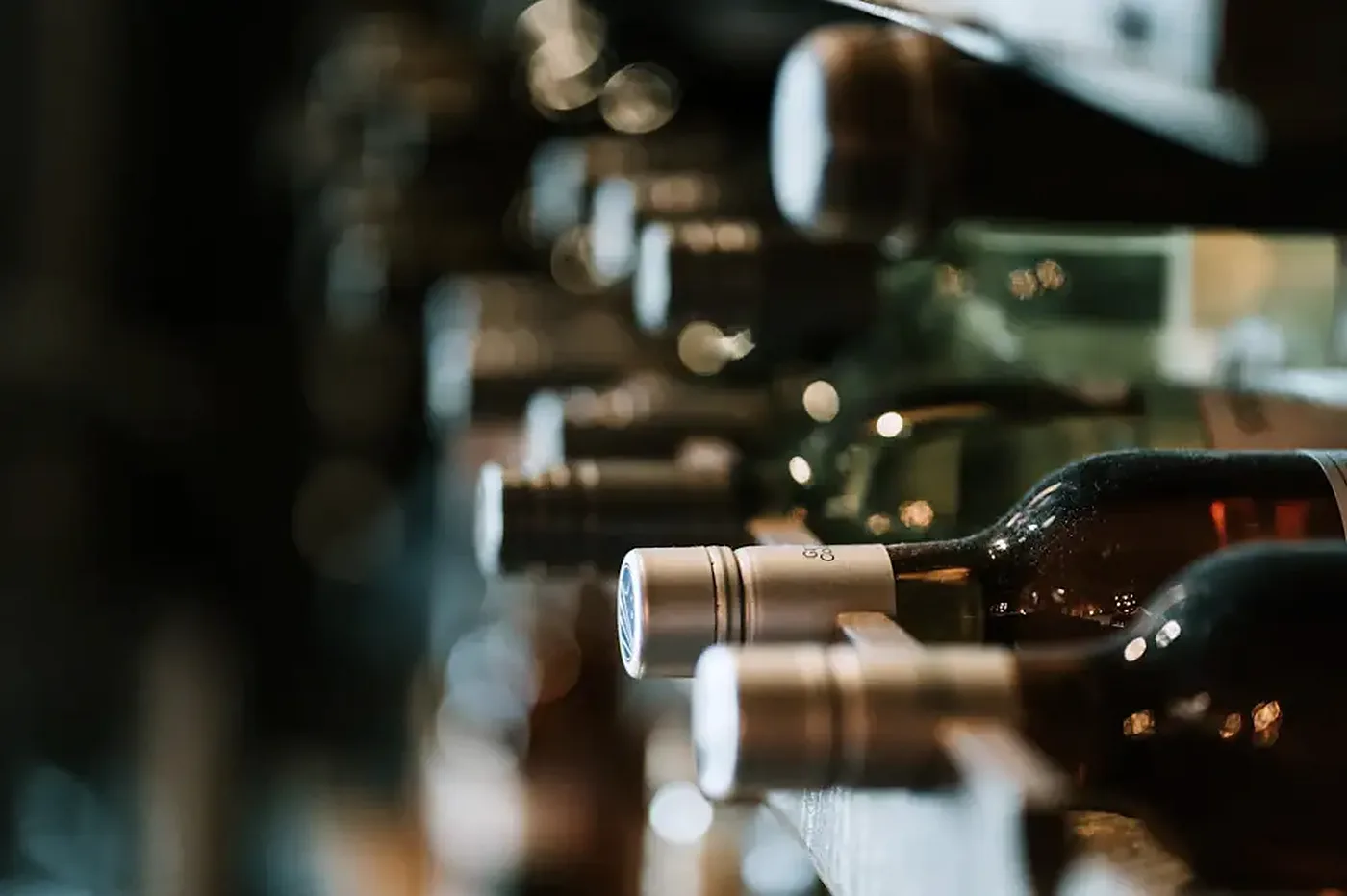 Bottles resting on their sides in a stone cellar